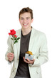 Valentines day. Portrait of young man holding the rose and gift over the white background
