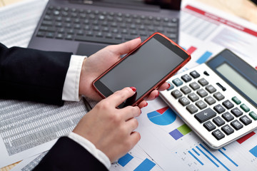 businesswoman holding cellphone in hand