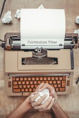 Poster - Curriculum vitae against above view of old typewriter