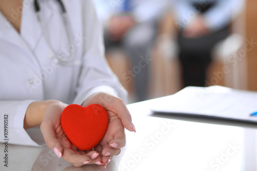 Pinturas sobre lienzo Female doctor with stethoscope holding heart