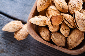 Wall Mural - Almonds in a wooden bowl. 