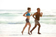 © mimagephotos - Fitness couple running along the sea on beach