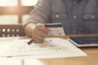 © 88studio - woman's hand holding credit card with tablet, selective focus an