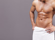 © cristovao31 - Fit man in towel on grey background