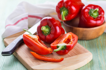 Wall Mural - Fresh organic bell peppers on a wooden board