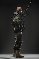 Wall Mural - soldier man hold Machine gun on a  dark background