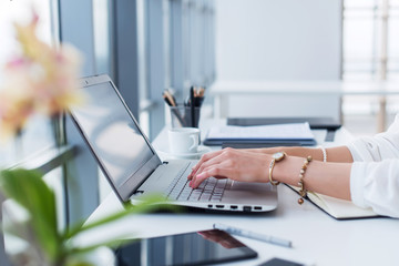 female copywriter at her workplace, home, writing new text using laptop and wi-fi internet connectio