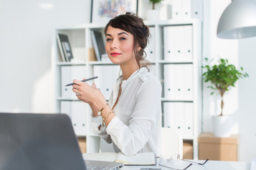 Wall Mural - Young attractive office worker drinking cup of tea, having coffee break in the morning, getting ready for work day.