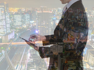 Wall Mural - Double exposure of businessman using touch screen device with ci