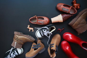 top view of collection of kids clothes on black background