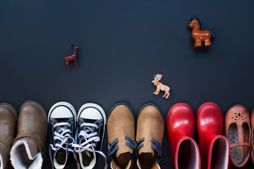 Wall Mural - top view of collection of kids clothes on black background