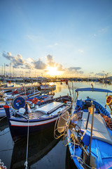 Boats in warm sunset light in Alghero, Sardinia