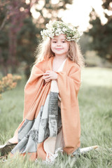 Wall Mural - Smiling baby girl 4-5 year old posing outdoors. Looking at camera. Childhood. 