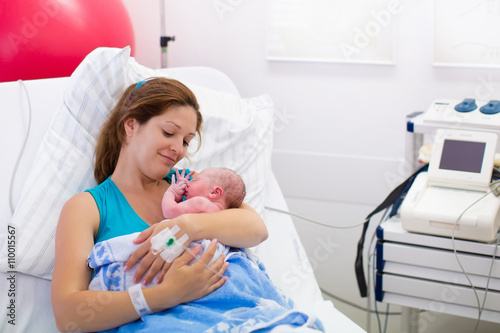 Mother Giving Birth To A Baby Newborn Baby In Delivery Room