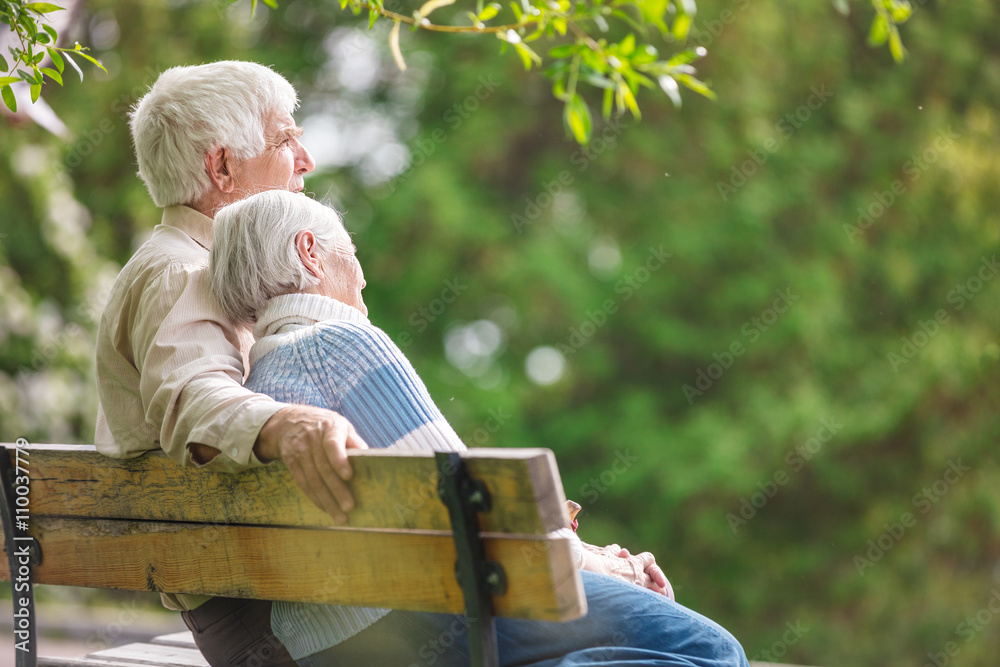 Elderly couple resting on a bench in the park Stock Photo | Adobe Stock