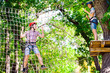 © davit85 - adventure climbing high wire park - people on course in mountain