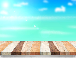 Poster - Wood table top with blurred sea,sun and beach at background, Moc