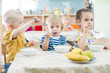 © Andrey Kuzmin - Funny kids group eating in kindergarten