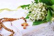 the first holy communion with rosary and flowers