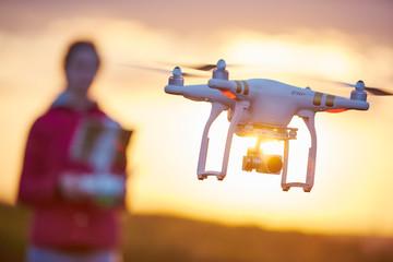 Wall Mural - drone quadcopter flying at sunset