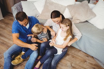 Poster - High angle view of happy family sitting by sofa