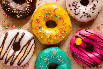 Wall Mural - Different tasty donuts on a background of paper