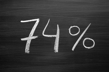 Wall Mural - 74 percent header written with a chalk on the blackboard