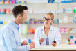 © pikselstock - Pharmacist and client at pharmacy