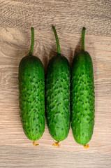 Cucumbers on a wooden background.