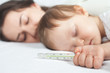Child has a high temperature or fever, using a thermometer
