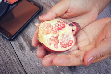 Wall Mural - Pomegranate fruit with hands