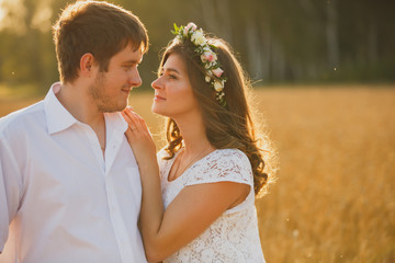 romantic happy couple go on a wheat field.