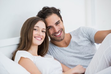 Happy couple relaxing on bed