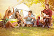 © luckybusiness - young people enjoy in music of drums and guitar on camping trip