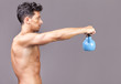 © cristovao31 - Young fitness male exercise with kettle bell on grey background