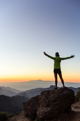 Wall Mural - woman climber success silhouette in inspiring mountains