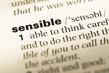 Wall Mural - close up of old english dictionary page with word sensible
