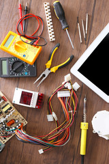 Poster - different electrical tools on wooden table, top view