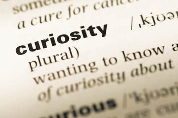 Wall Mural - close up of old english dictionary page with word curiosity