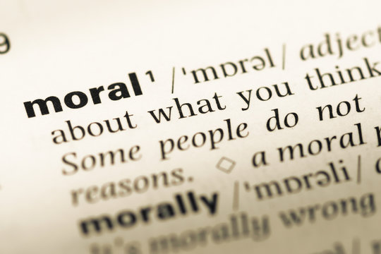 Close up of old English dictionary page with word moral