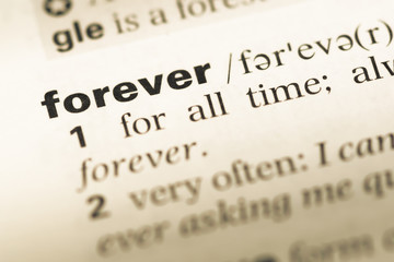 close up of old english dictionary page with word forever