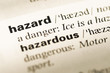 Close up of old English dictionary page with word hazard