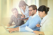 © goodluz - Group of business people working on laptop