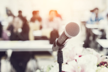 Microphone on the desk in meeting room with blur people backgrou