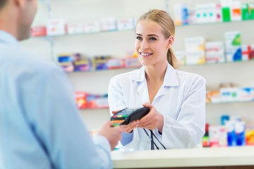 Wall Mural - Pharmacist and client at pharmacy
