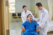 © DragonImages - Smiling senior patient and doctor talking after surgery