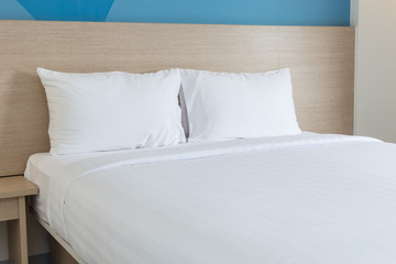 White bedding sheets and pillow in hotel room