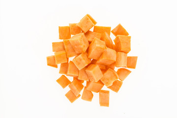 Fresh sweet potato cut into cubes , isolated on white background