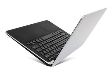 Flying aluminium laptop, isolated on a white background.