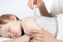 Child Has A High Temperature Or Fever, Using A Thermometer